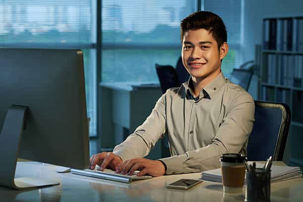 Portrait of cheerful Filipino businessman at his workplace